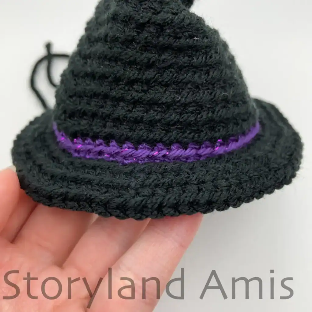 Close-up of a black witch's hat, showing the completed brim of the hat.