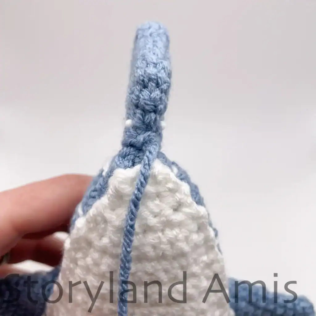 The tail fin on a crocheted whale shark.