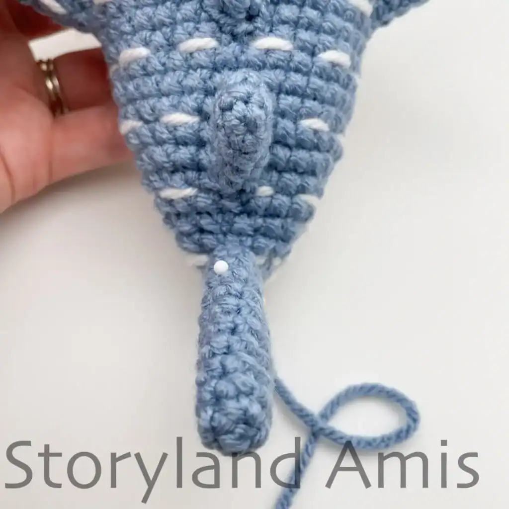 The tail fin on a crocheted whale shark.