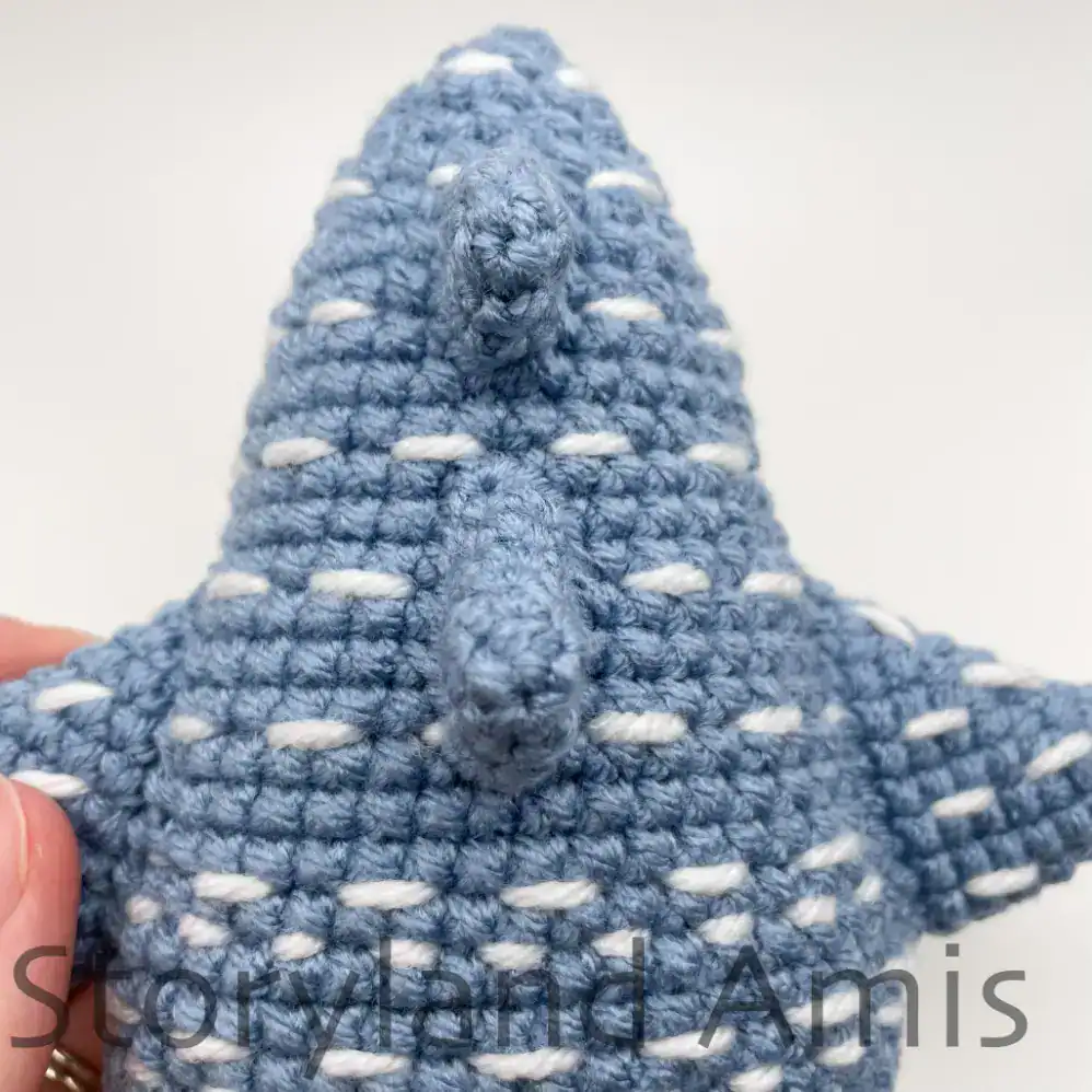 The back fins on an amigurumi whale shark are shown from the top.