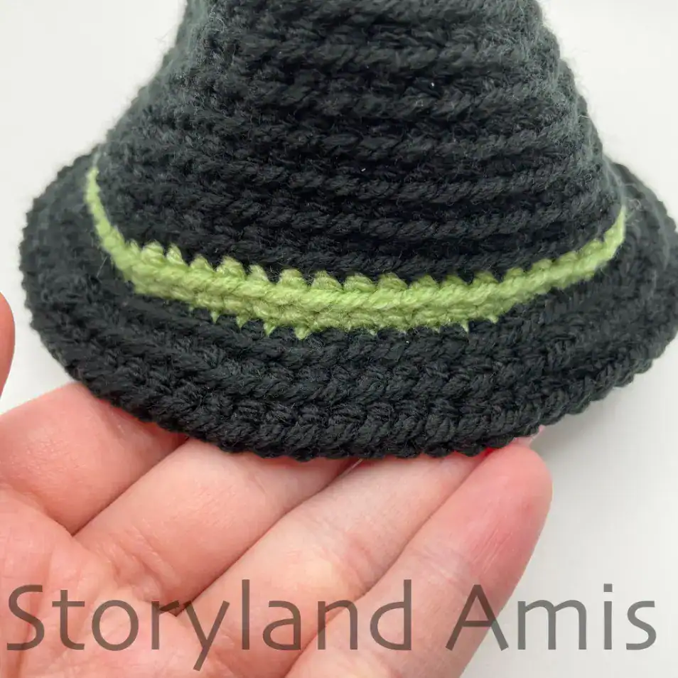 A close-up of the brim of a black crocheted witch's hat for an amigurumi pumpkin.