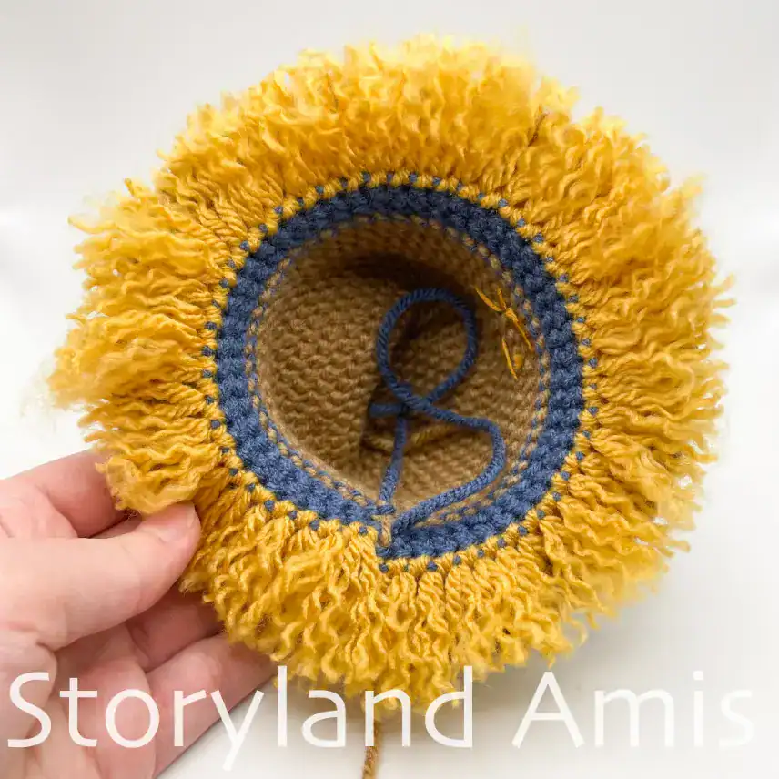 A close-up of the bottom of a crocheted hat for an amigurumi scarecrow.