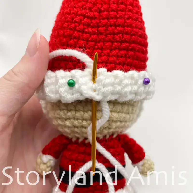 A close-up of the back of an amigurumi Santa Claus.