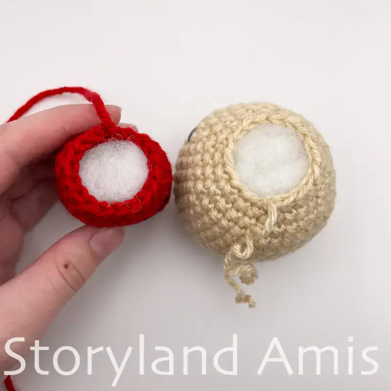 A crocheted head and body, side-by-side, shown from the top.