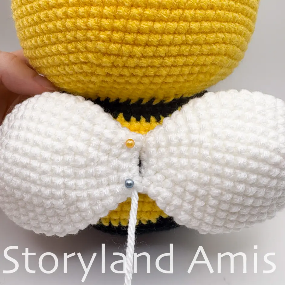A close-up of the back of an amigurumi bee, showing the position of the wings.