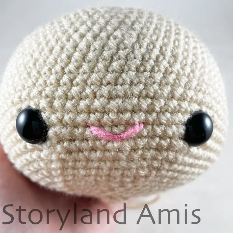 A close-up of an amigurumi doll head.