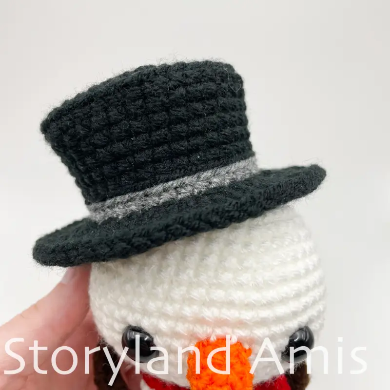 A close-up of an amigurumi snowman's hat.