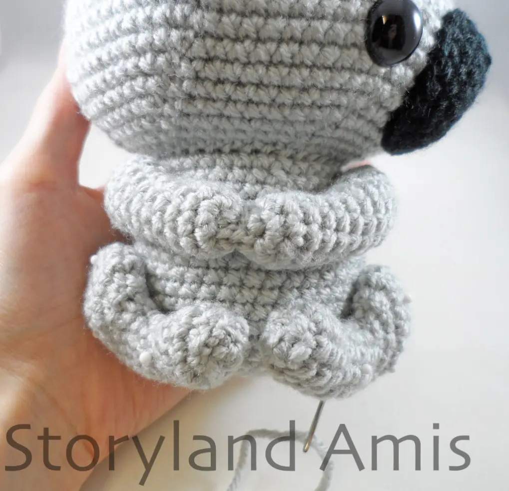 A close-up of an amigurumi koala's arms and legs.