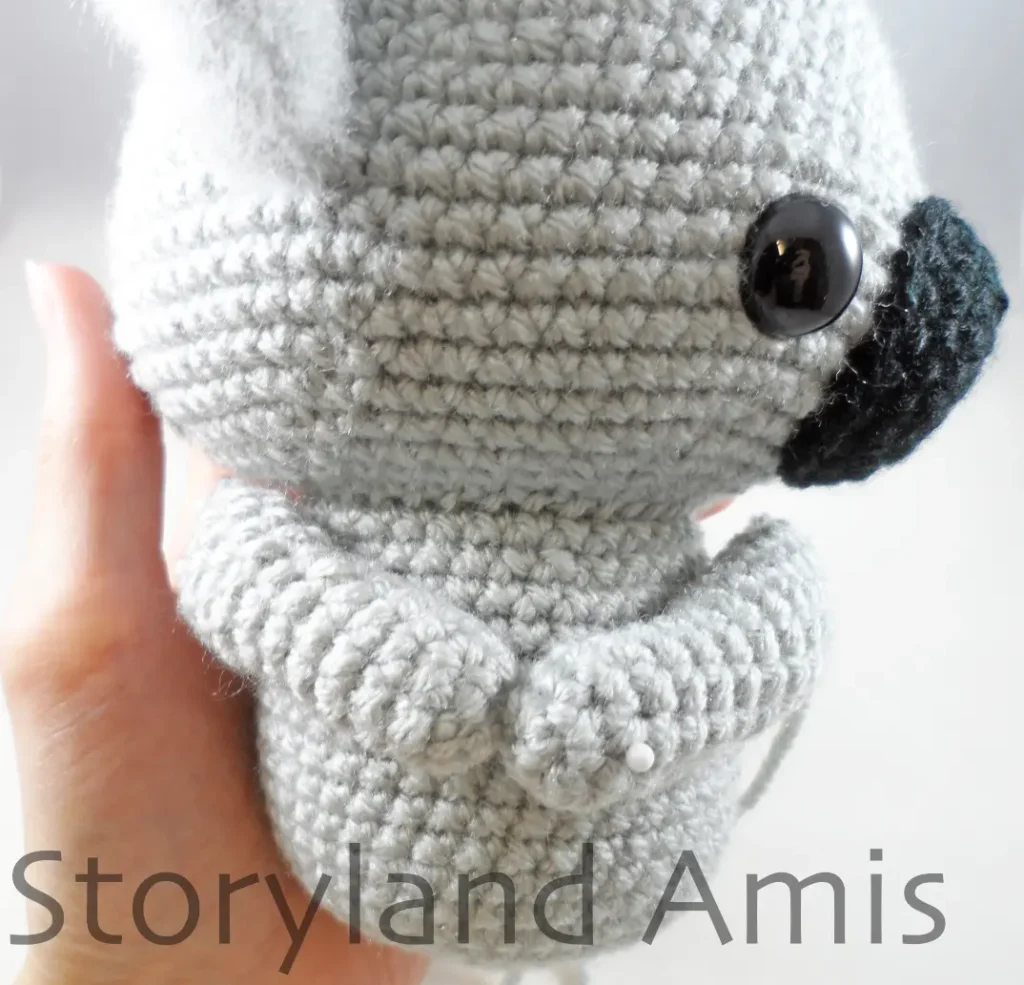 A close-up of the side of a work-in-progress amigurumi koala.