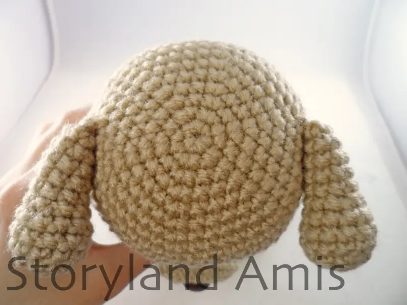 A close-up of the bottom of an amigurumi puppy dog.
