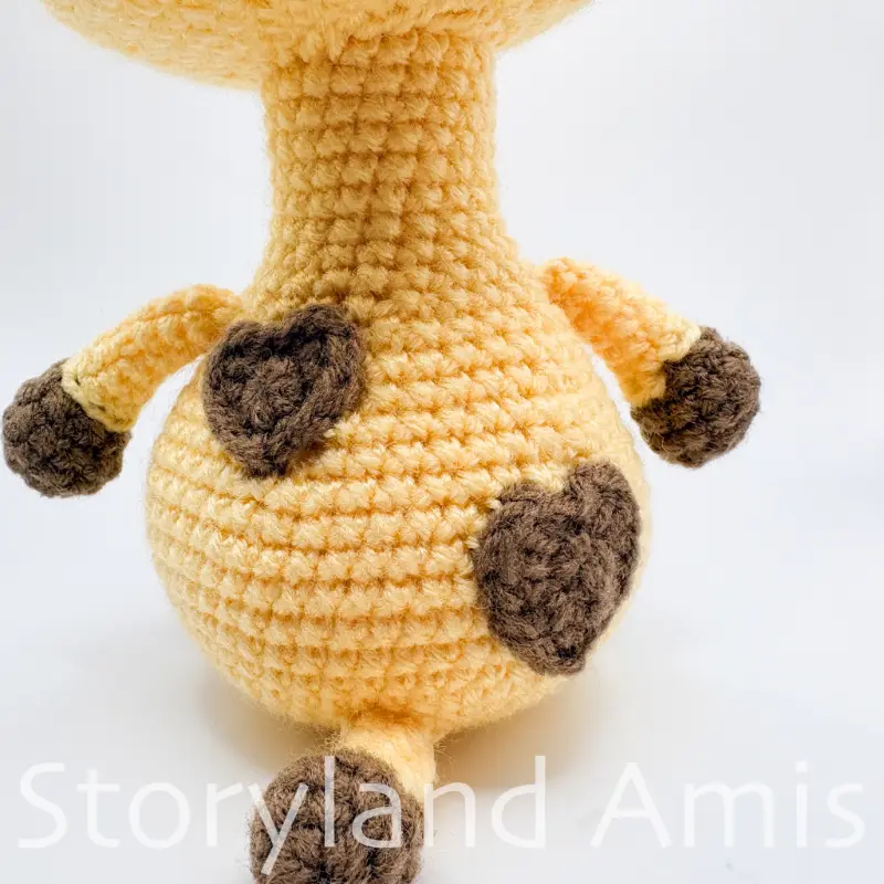 A close-up of the back of the body of an amigurumi giraffe.