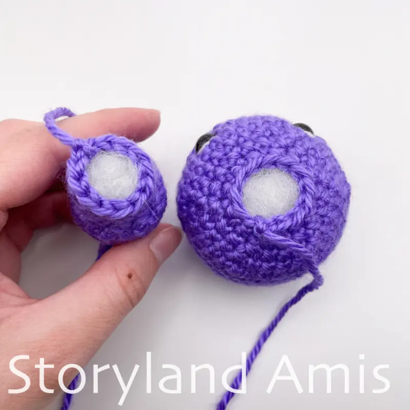 A purple crocheted seahorse head and body, shown from above, sit beside each other on a white background.