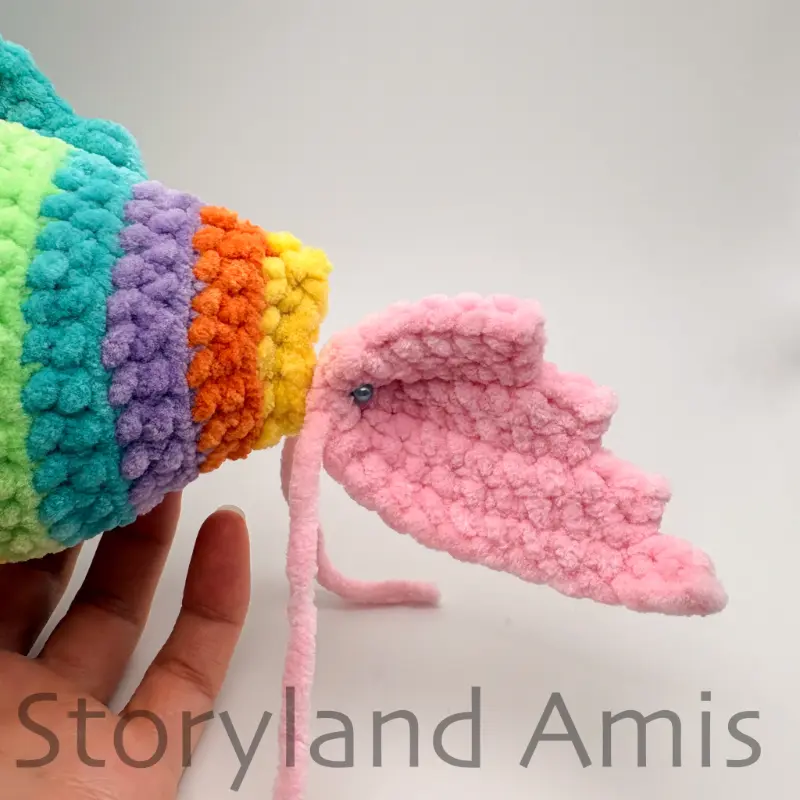 A close-up of the tail fin of a crocheted fin pinned to the back of the fish.