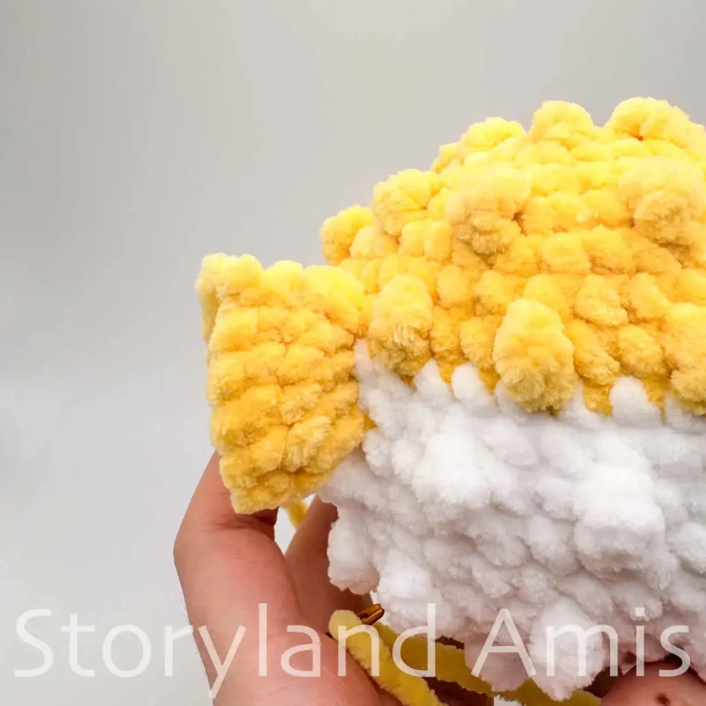A close-up of the tail fin on an amigurumi pufferfish toy.